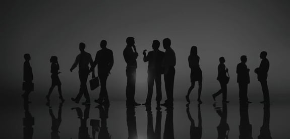 Photo: A group of coworkers standing and discussing