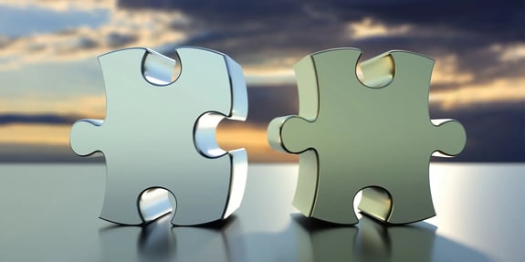 Image: Two 3D puzzle pieces getting together.