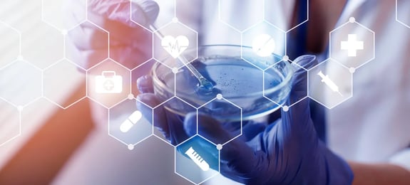 A Cleanroom Operator holding a petri dish to detect microbial contamination