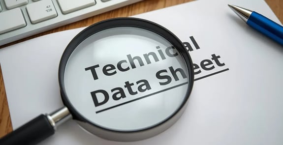 Magnifying glass examining technical data sheet - concept image for analyzing cleanroom consumable product specifications and test data.