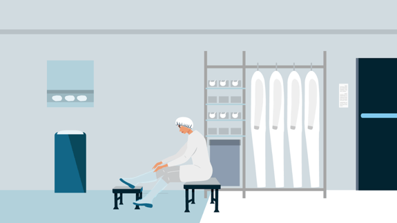 A Cleanroom operator donning cleanroom apparel in a gowning room.