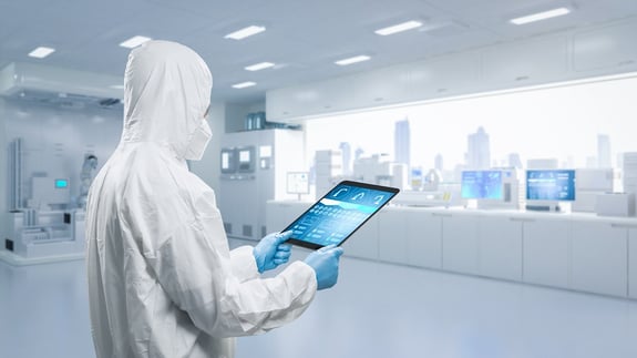 A cleanroom operator wears protective cleanroom coverall in a cleanroom.
