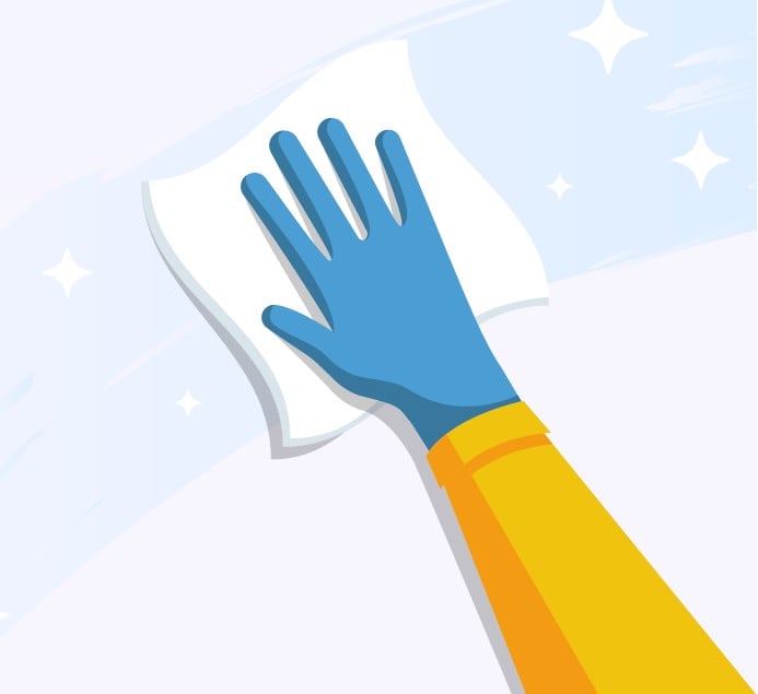 A cleanroom operator who wears blue nitrile gloves wipes a surface with a fan-fold dry wiper.